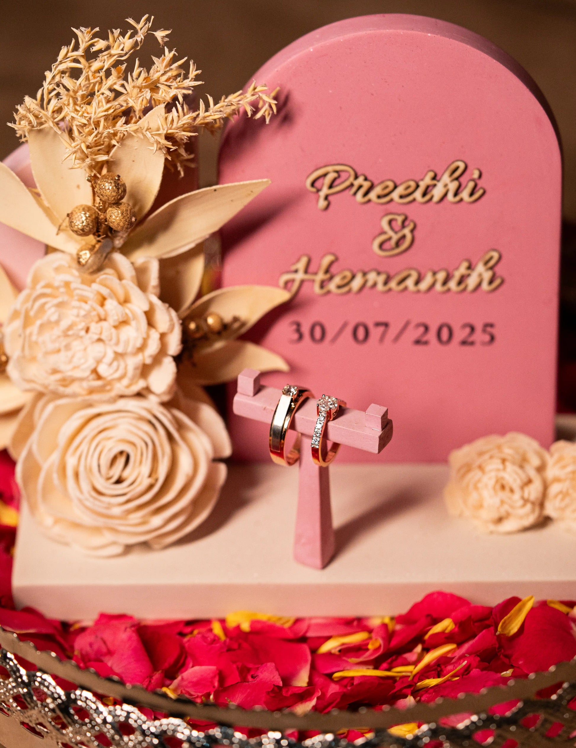 “Navya ring platter with two wedding rings and engraved names”